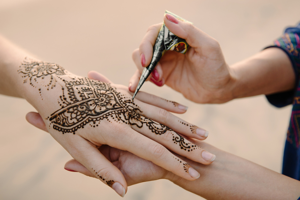 Applying Henna Tattoo on Women Hands